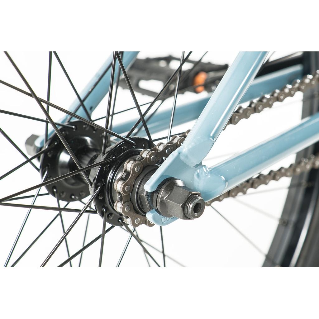 Close-up of the rear wheel hub, axle, chain, and spokes on the blue chromoly frame of the Colony Eclipse 24 Inch Bike against a white background.