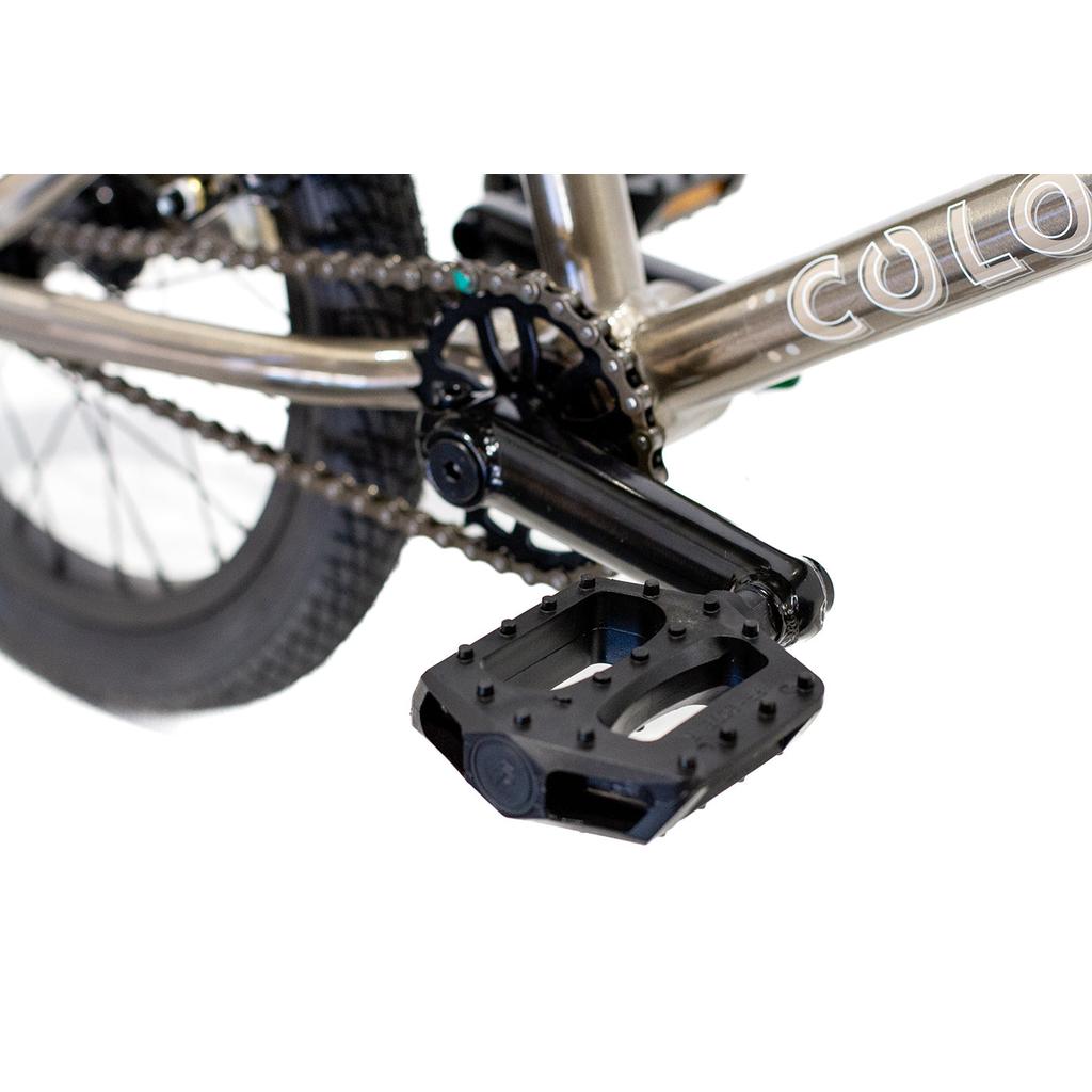 Close-up of a black pedal, crank arm, chain, and rear wheel on the Colony Horizon 16 Inch Bike’s lightweight alloy frame.