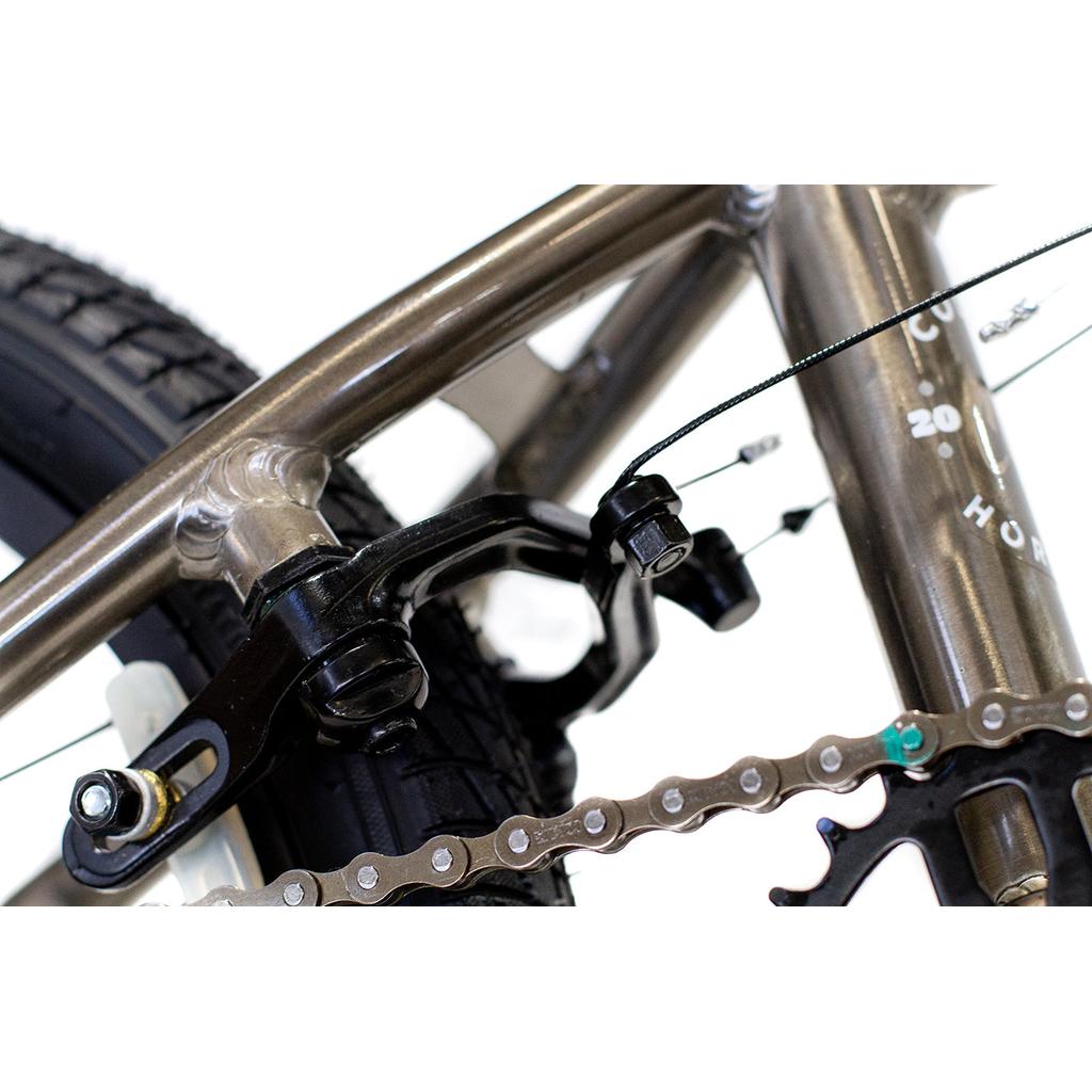 Close-up of the Colony Horizon 16 Inch Bike's rear tire, chain, and brake caliper, showcasing its lightweight alloy frame and detailed mechanical design.