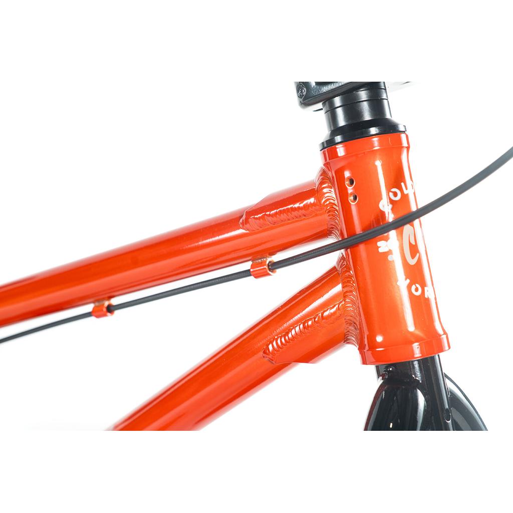 Close-up of the Colony Horizon 20 Inch Bike frame in orange, showing detailed welds and black cables—ideal for aspiring freestyle Olympic athletes.