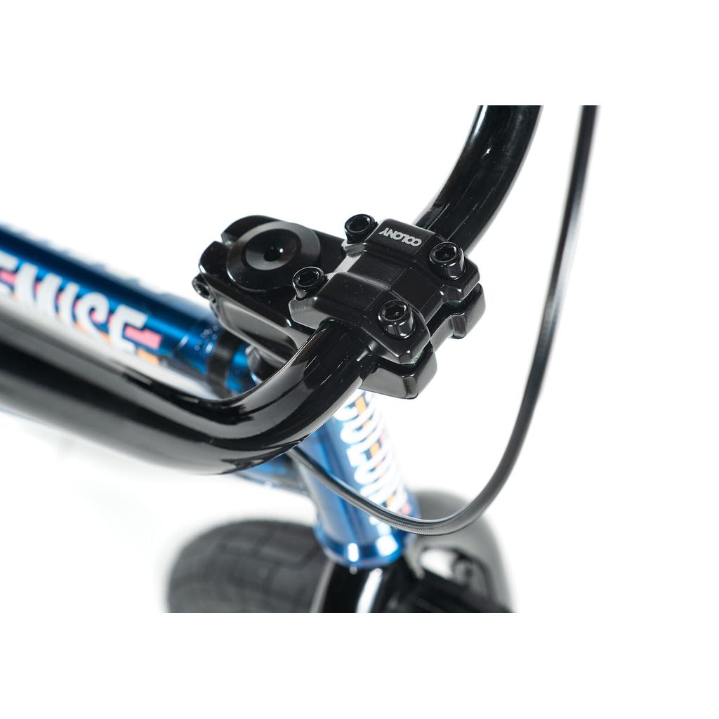 Close-up of colony-premise-bike-2020 handlebars and blue stem with visible bolts, plus a partial view of the front tire.