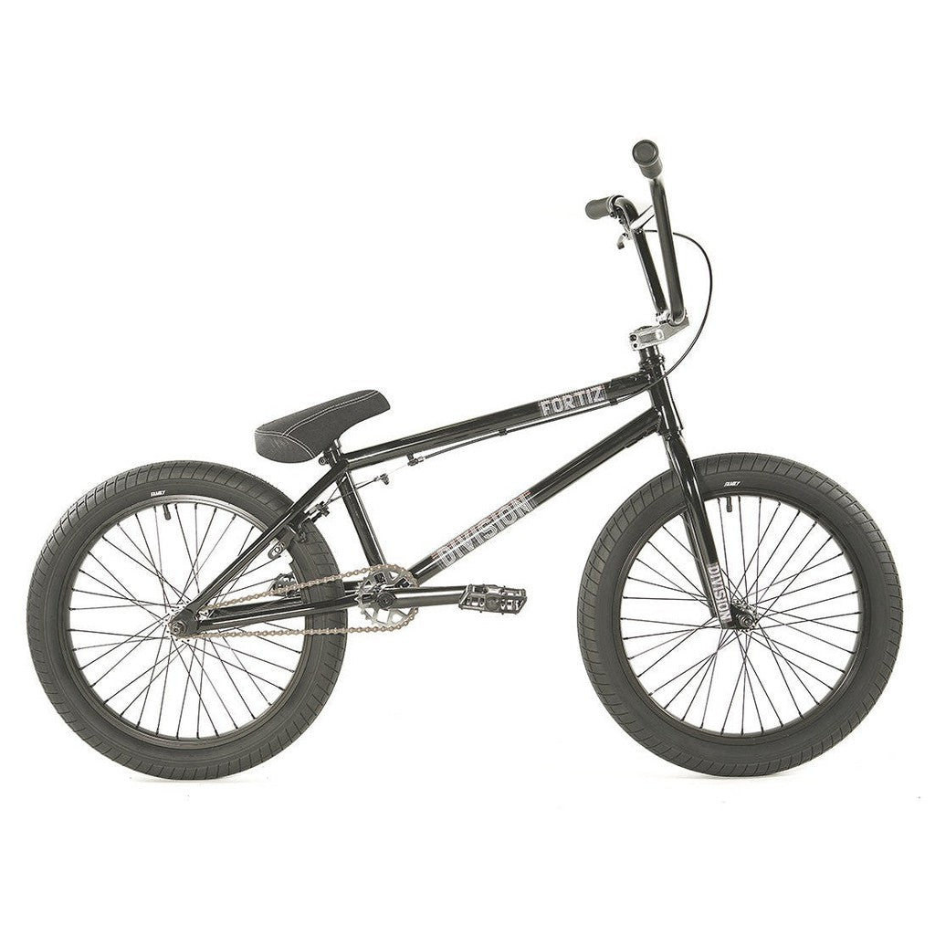 A black Division Fortiz 20 Inch bike with thick tires, a padded seat, and "Division Fortiz" emblazoned on the frame. The bike features rear pegs, a Chromoly frame, and a sturdy build.