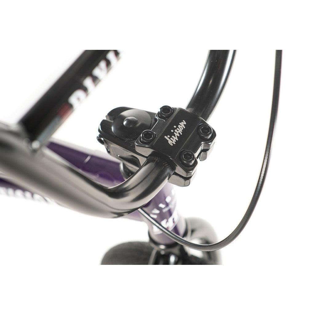 Close-up of the Division Blitzer 16 Inch Bike's black handlebars with a four-bolt stem, displaying "Division" in white. This entry-level BMX bike highlights scaled-down geometry, with the cable visible on the right side.