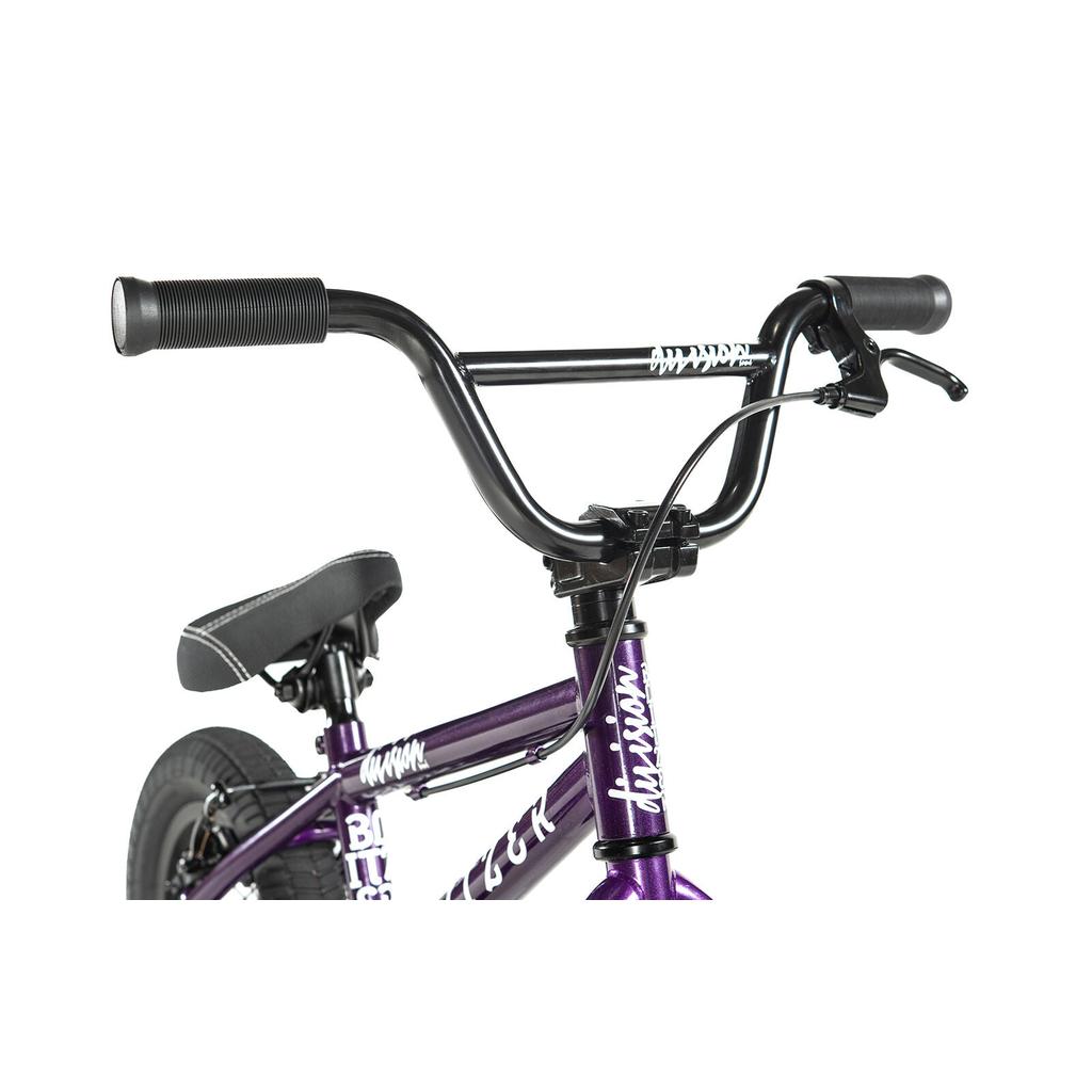 Close-up of the Division Blitzer 12 Inch Bike in purple, featuring the handlebars, brake lever, seat, and part of the frame against a white background.