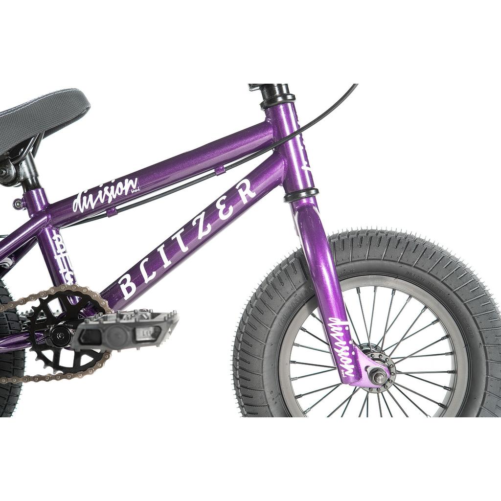 Close-up of the Division Blitzer 12 Inch Bike in purple, featuring labeled frame, pedal, crank, chain, rear seat, and front tire—ideal for young riders seeking a stylish kids’ BMX.