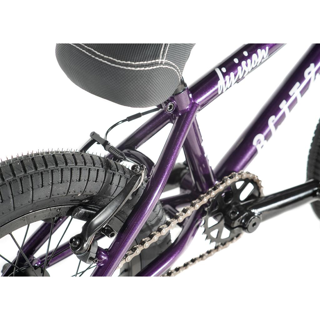 Close-up of the Division Blitzer 14 Inch Bike in purple, highlighting its rear wheel, tire tread, chain, black crankset, and rear brake—perfect for young BMX riders.