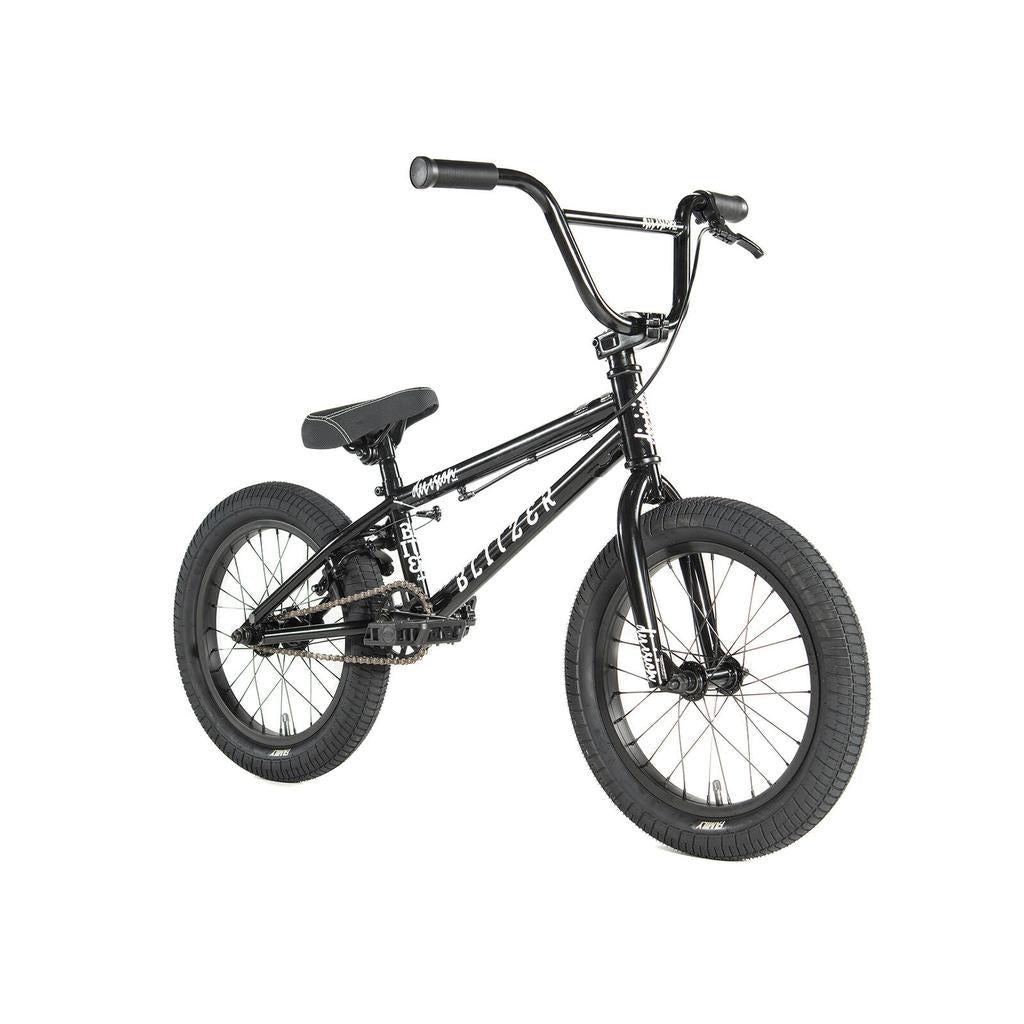The Division Blitzer 16 Inch Bike is a black BMX with thick 16-inch wheels, a padded seat, and raised handlebars, displayed at a three-quarter angle on a white background.