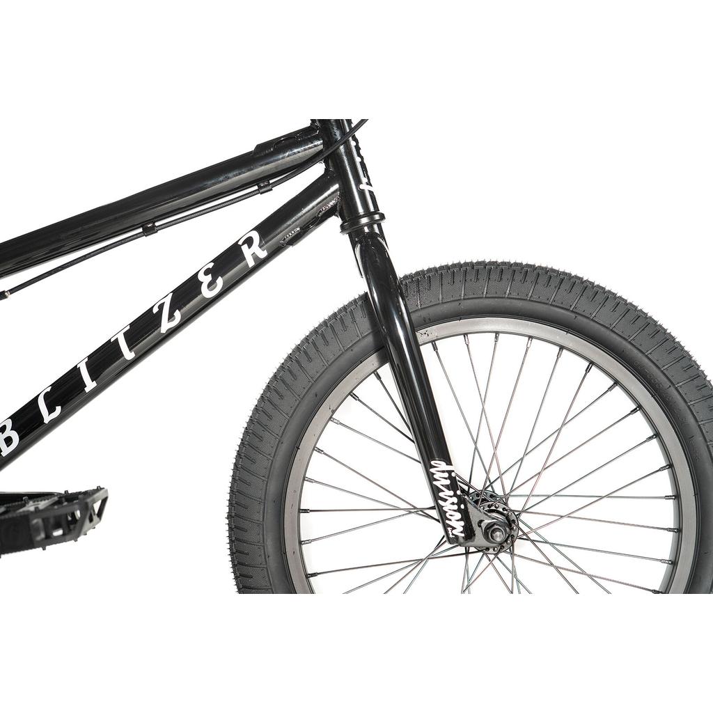 Close-up of the front wheel and fork of the Division Blitzer 18 Inch Bike, featuring a black Hi-Ten frame with "BLITZER" on it, shown against a white background.