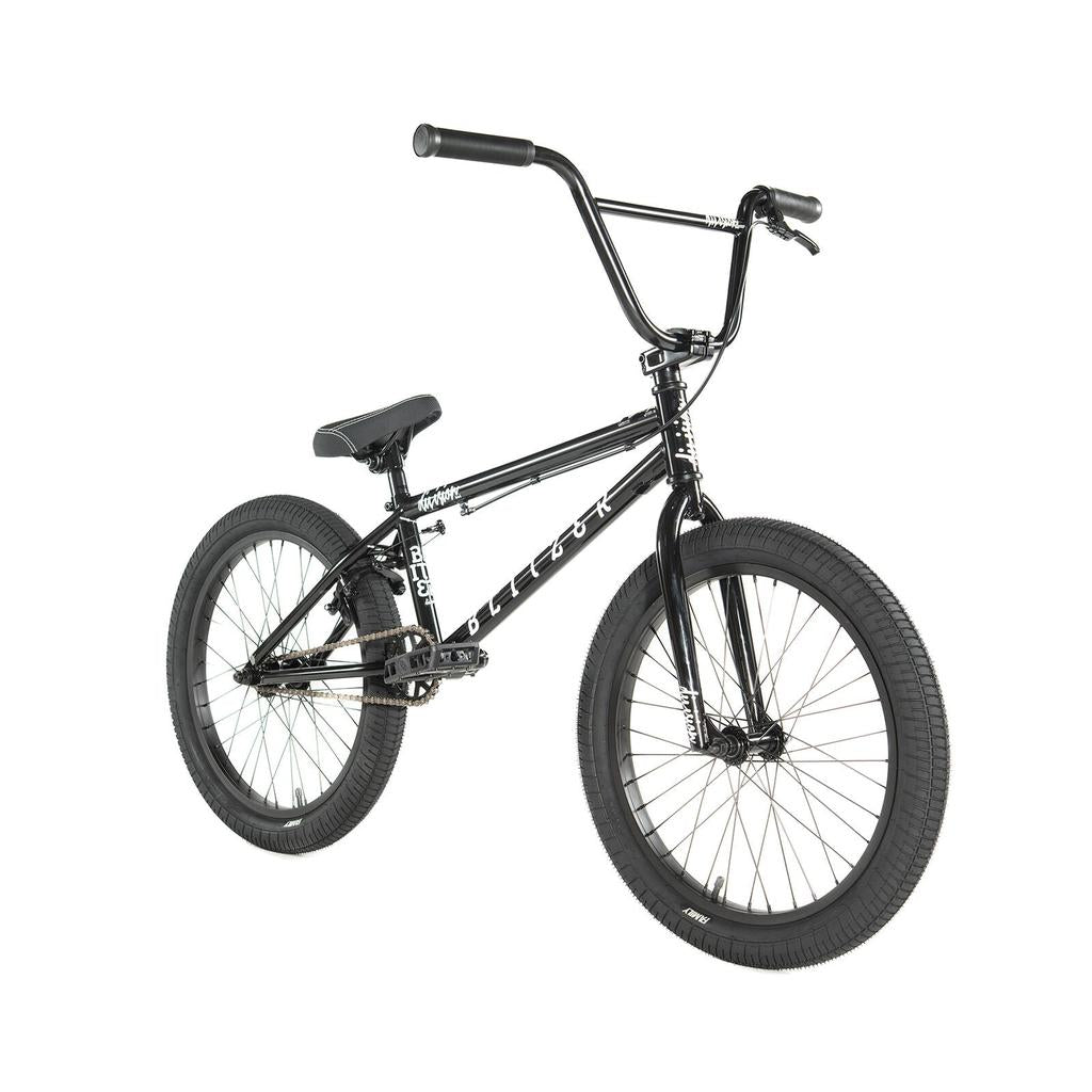 The Division Blitzer 20 Inch Bike is a black beginner BMX with large handlebars, padded seat, thick tires, metal pedals, and 20” wheels, shown on a white background.