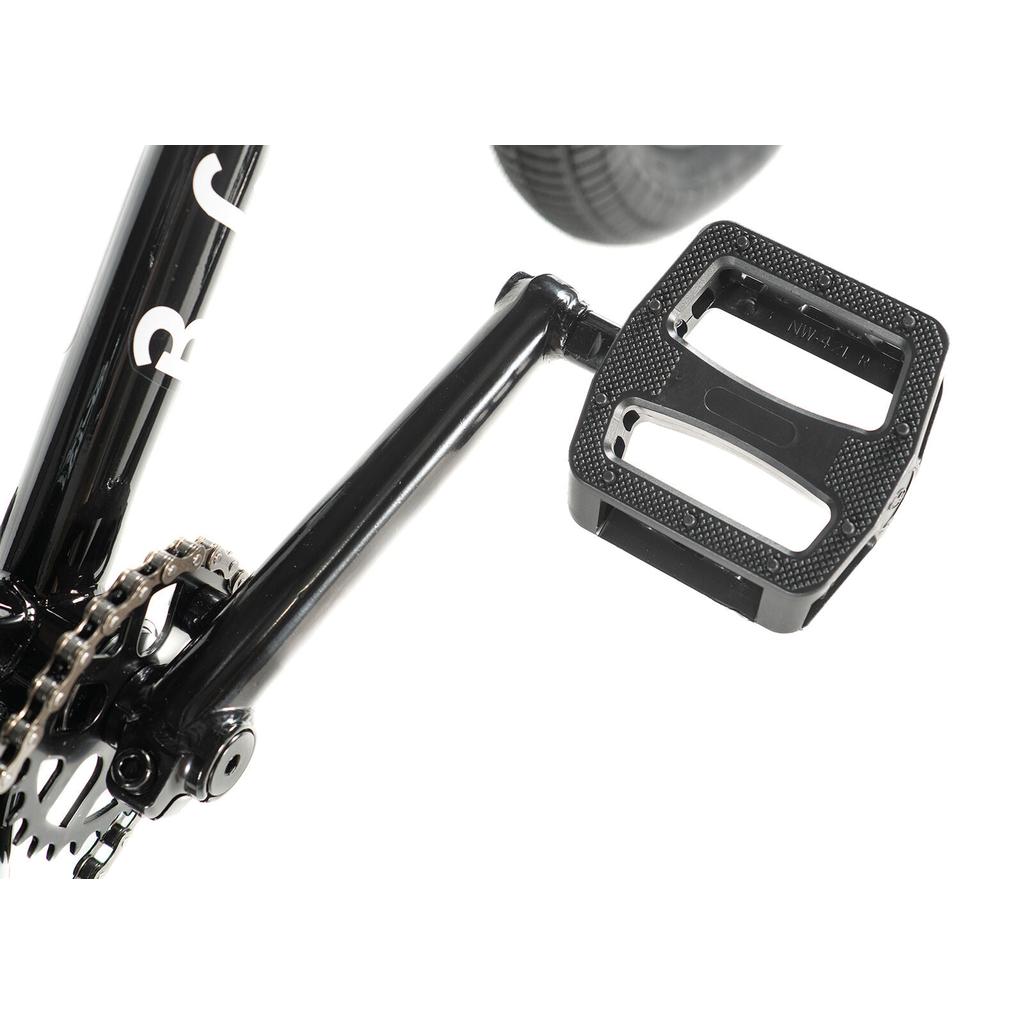 Close-up of a black pedal and crank arm on the Division Blitzer 20 Inch Bike BMX, showing the chain and rear tire—a great setup for beginner street riders with 20” wheels.