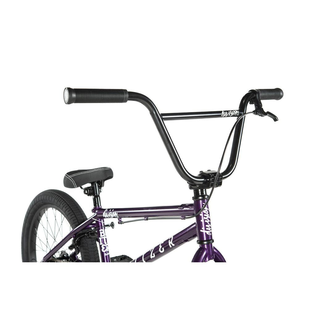 Close-up view of a black handlebar and seat on the Division Blitzer 20 Inch Bike, a purple BMX with 20” wheels, against a white background.