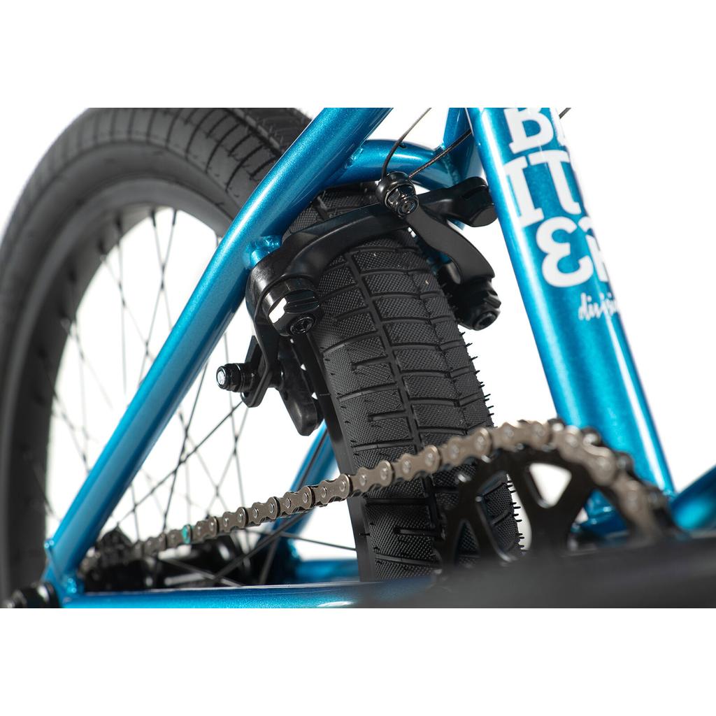 Close-up of the Division Blitzer 20 Inch Bike’s rear wheel, featuring its 20” wheels, tire, chain, and brake caliper set against a white background.