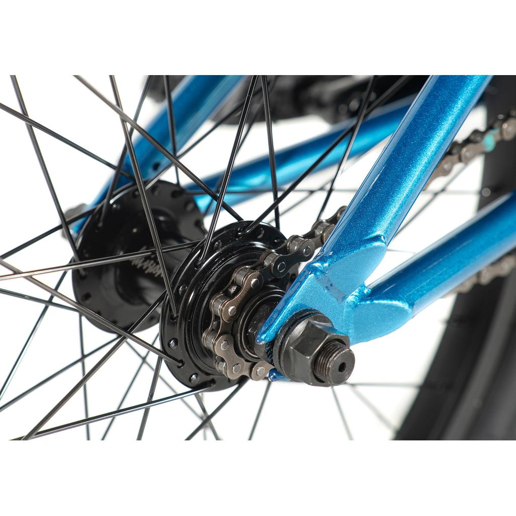 Close-up of the Division Blitzer 20 Inch Bike’s rear wheel, showcasing the chain, sprocket, spokes, and part of the frame—ideal for beginners seeking a street BMX with 20” wheels.