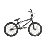 The Division Reark 20 Inch Bike is a black BMX with thick tires, lightweight Hi-Tensile steel frame, padded seat, straight handlebars, rear pegs, and sealed bottom bracket—shown in profile against a white background.