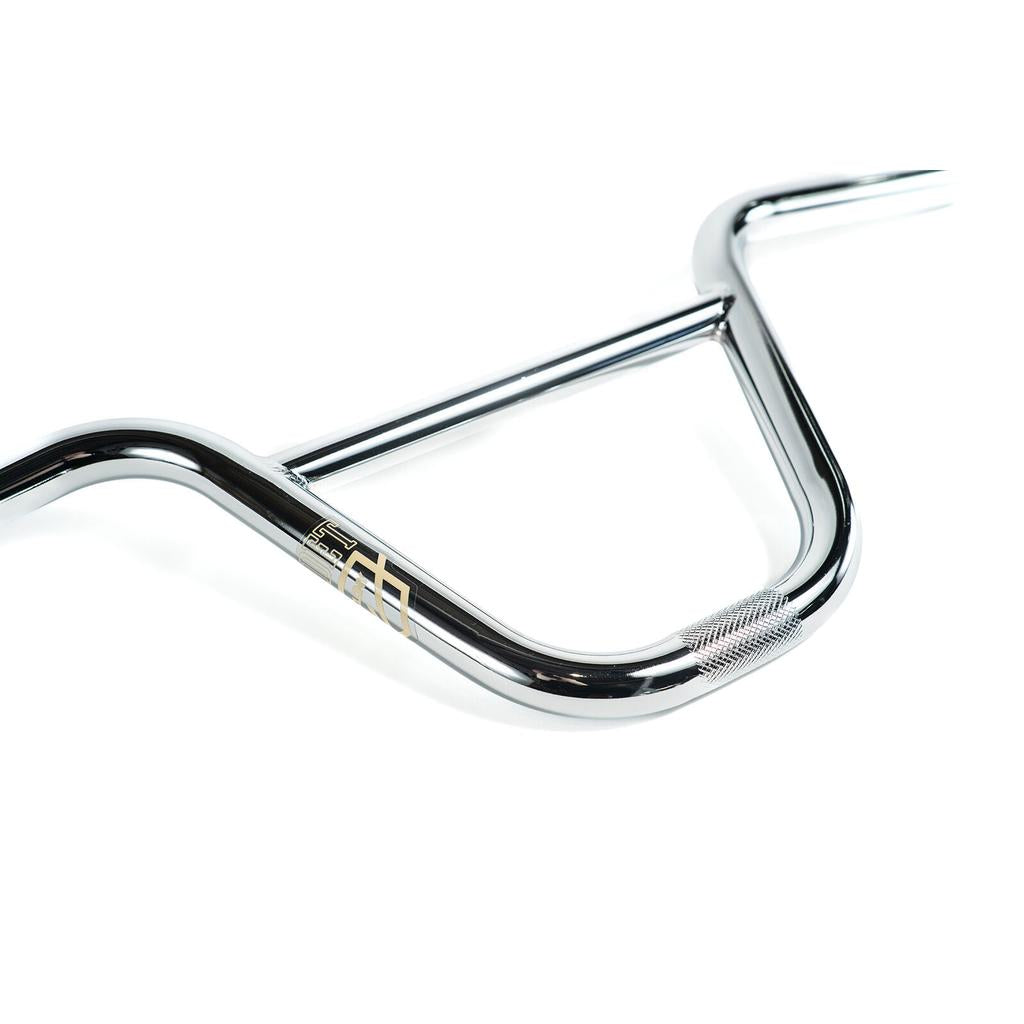 The Colony Cadet Bars are chrome BMX handlebars with a knurled clamping area, ideal for freestyle riders seeking 18-inch BMX bars. They feature a small gold Colony logo on a white background.