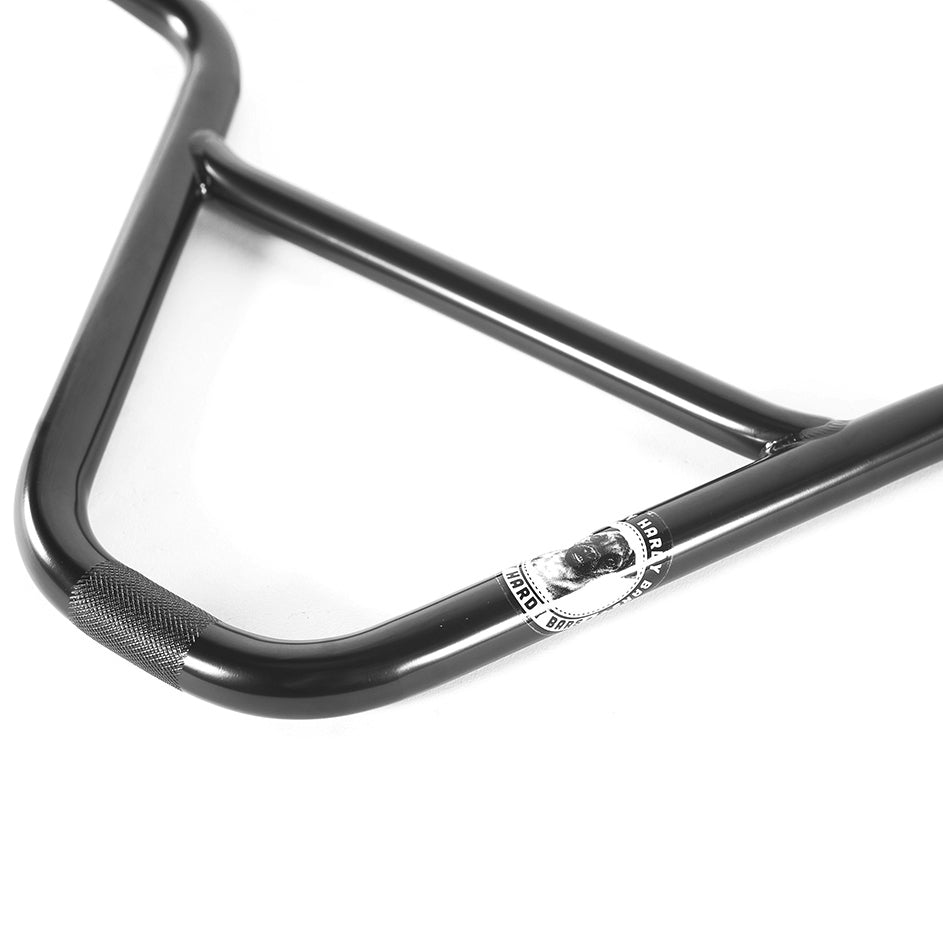 The Colony Hardy V2 Bars BMX bike handlebars feature a black D shape with textured grip and a logo sticker of a person's face, combining style and performance in every ride.