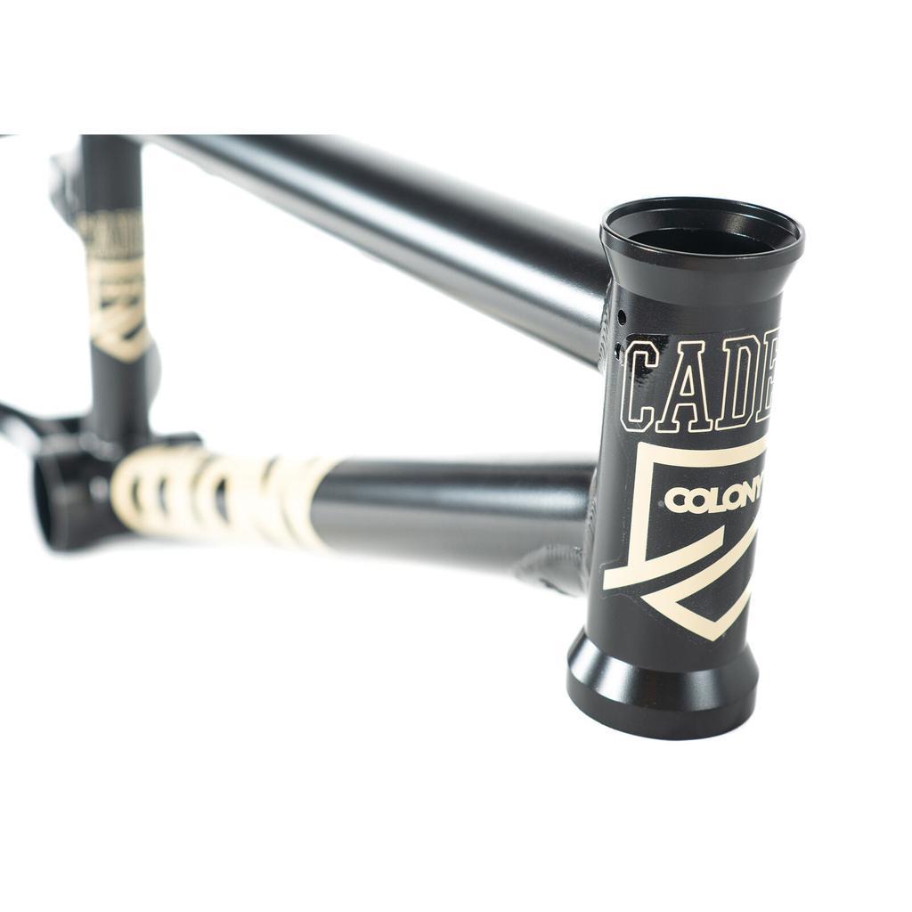Close-up of the Colony Cadet 16 Inch Frame in black, featuring beige "CADET" and "COLONY" branding on the head tube and down tube, built with strong CrMo construction.