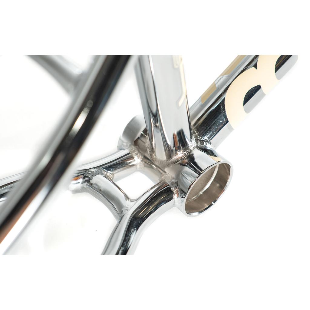 Close-up of the Colony Cadet 16 Inch Frame's polished CrMo bottom bracket area, displaying welds and tubing against a white background.