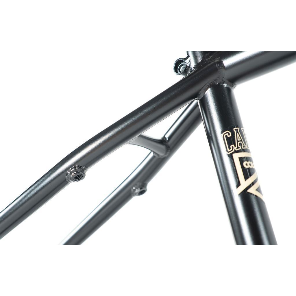Close-up view of a matte black Colony Cadet 18 Inch Frame, constructed from chromoly with visible welds and mounting points, and displaying the "Cadet" logo in light-colored lettering.