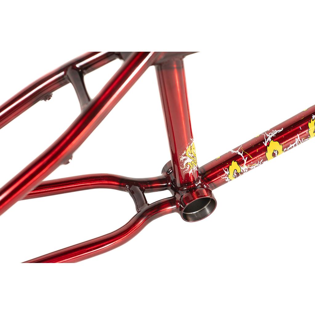 Close-up of the Colony Injustice Frame (Tom Justice Signature) in metallic red, showcasing yellow and white graphic details near the bottom bracket area and featuring Tom Justice’s signature on its durable 4130 CrMo tubing.