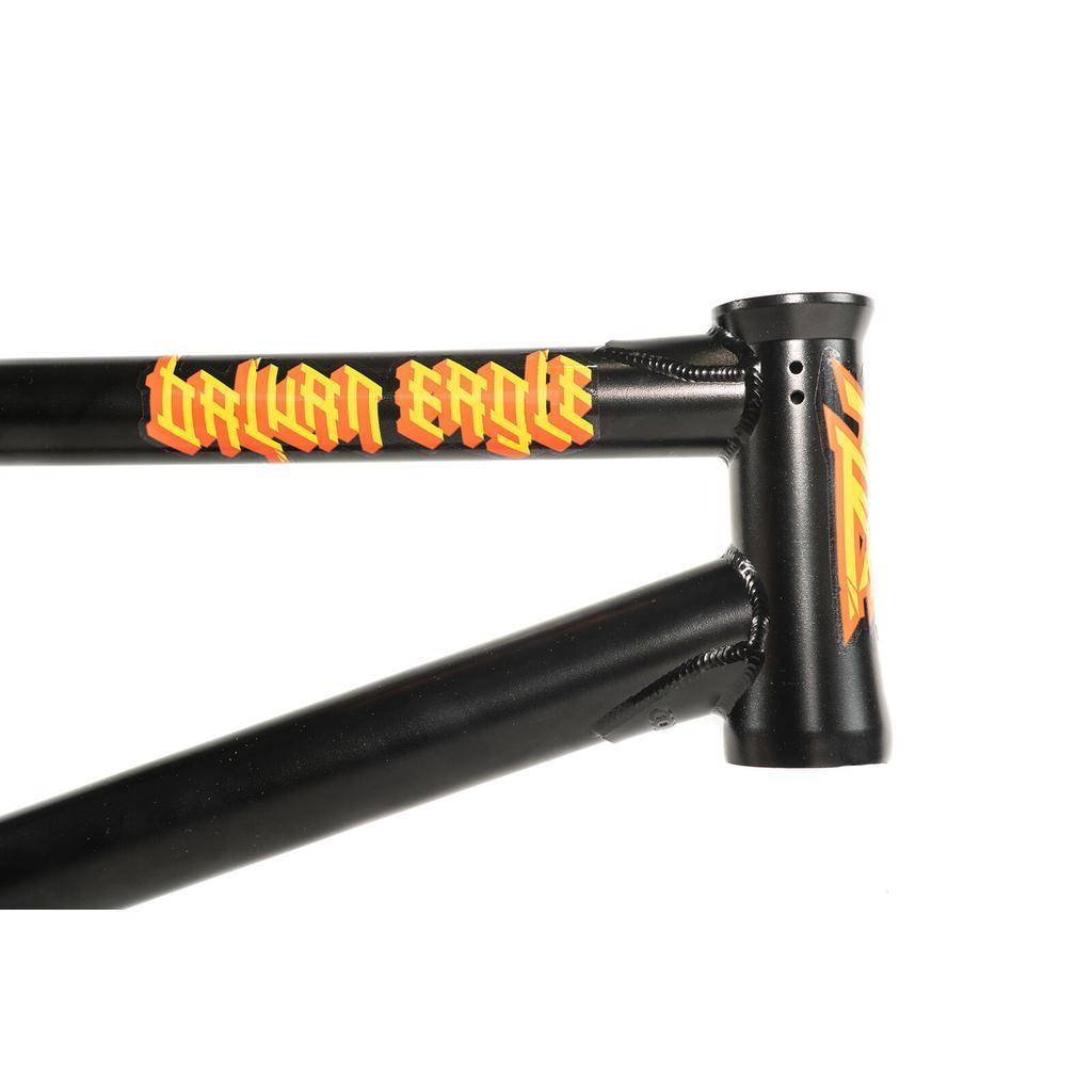The Colony Balkan Eagle Frame (Renato Rancso Signature) in black, featuring "Balkan Eagle" in yellow and red stylized lettering on the top tube, is shown in a close-up highlighting part of the head tube and evoking the classic Renato Rancso frame design.
