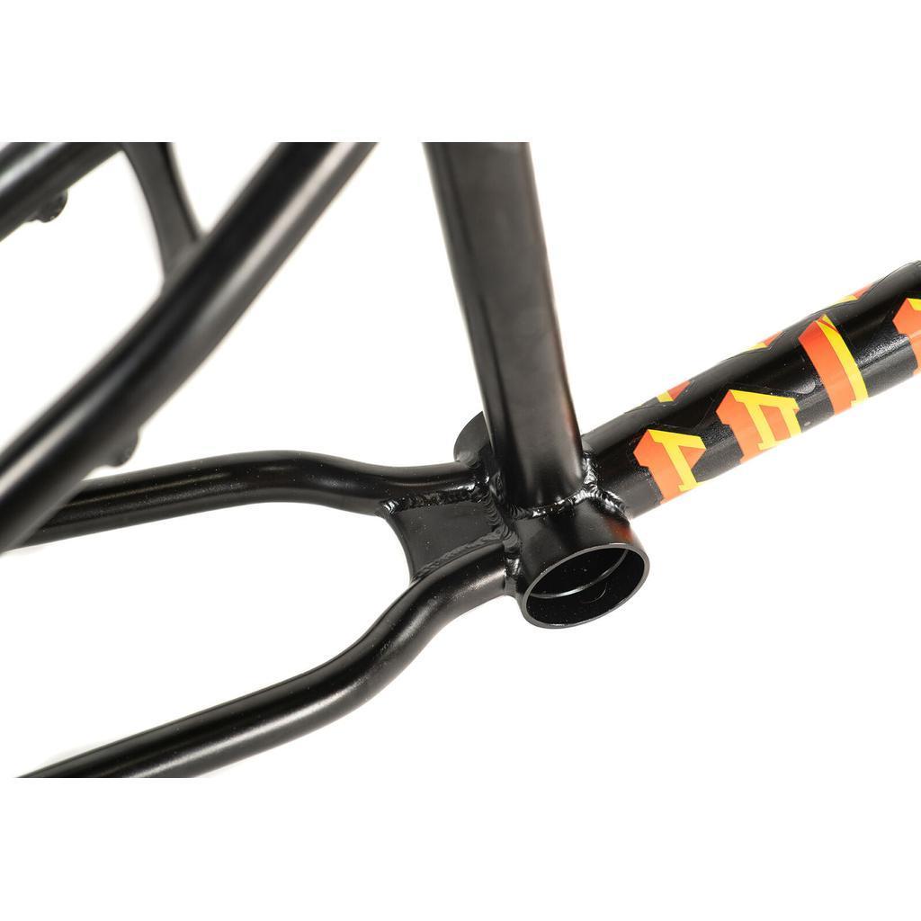 Close-up of a black Colony Balkan Eagle Frame (Renato Rancso Signature) bottom bracket area, highlighting precise welding details and a section of the 4130 CrMo frame adorned with bold orange and yellow graphics.
