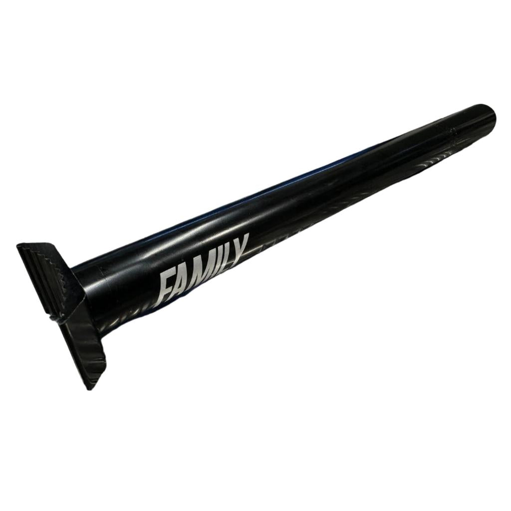 The Family Pivotal Seat Post, featuring a black metal finish and labeled "FAMILY," rests on a silver, diamond-patterned surface, highlighting its sturdy 25.4mm diameter.