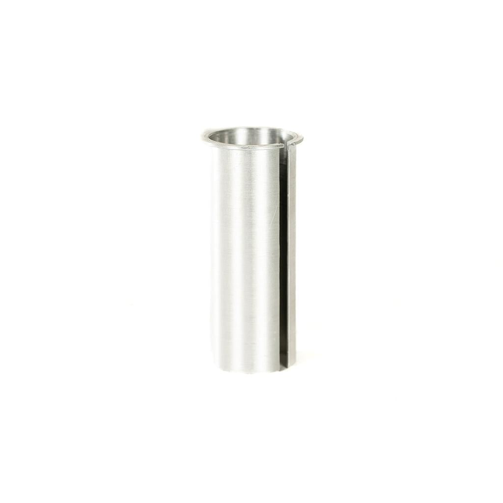 The Colony Horizon Seat Post Shim (27.2-25.4mm) is a cylindrical metal adapter with a vertical slot, designed to fit 25.4mm seat posts into 27.2mm frames, shown upright on a white background.