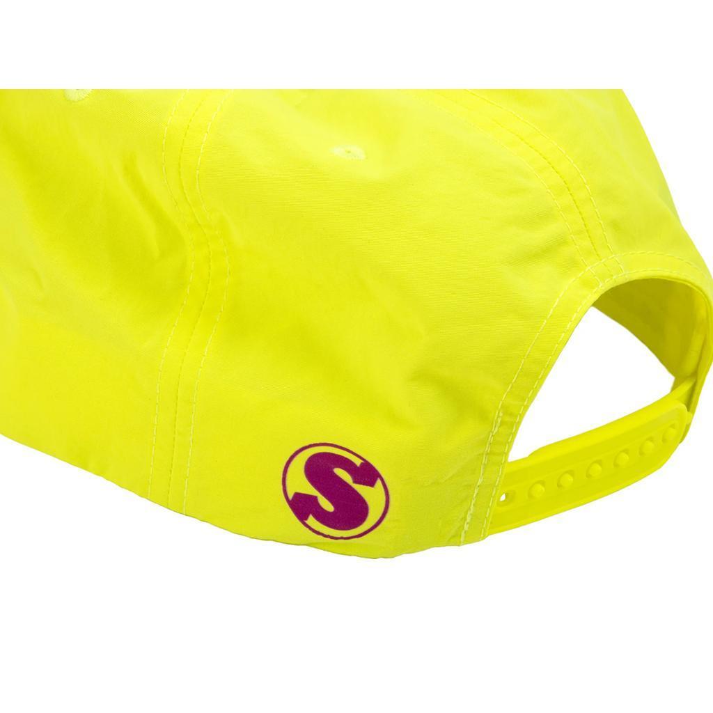 A close-up of the back of a bright yellow Sunday High Wave Cap, showcasing a purple "S" logo near the adjustable strap—ideal for Back to School 2025.
