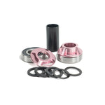 The Colony Bottom Bracket features lightweight 6061 alloy components: pink anodized cups, bearings, a black tube spacer, and several black washers, all displayed on a white background.