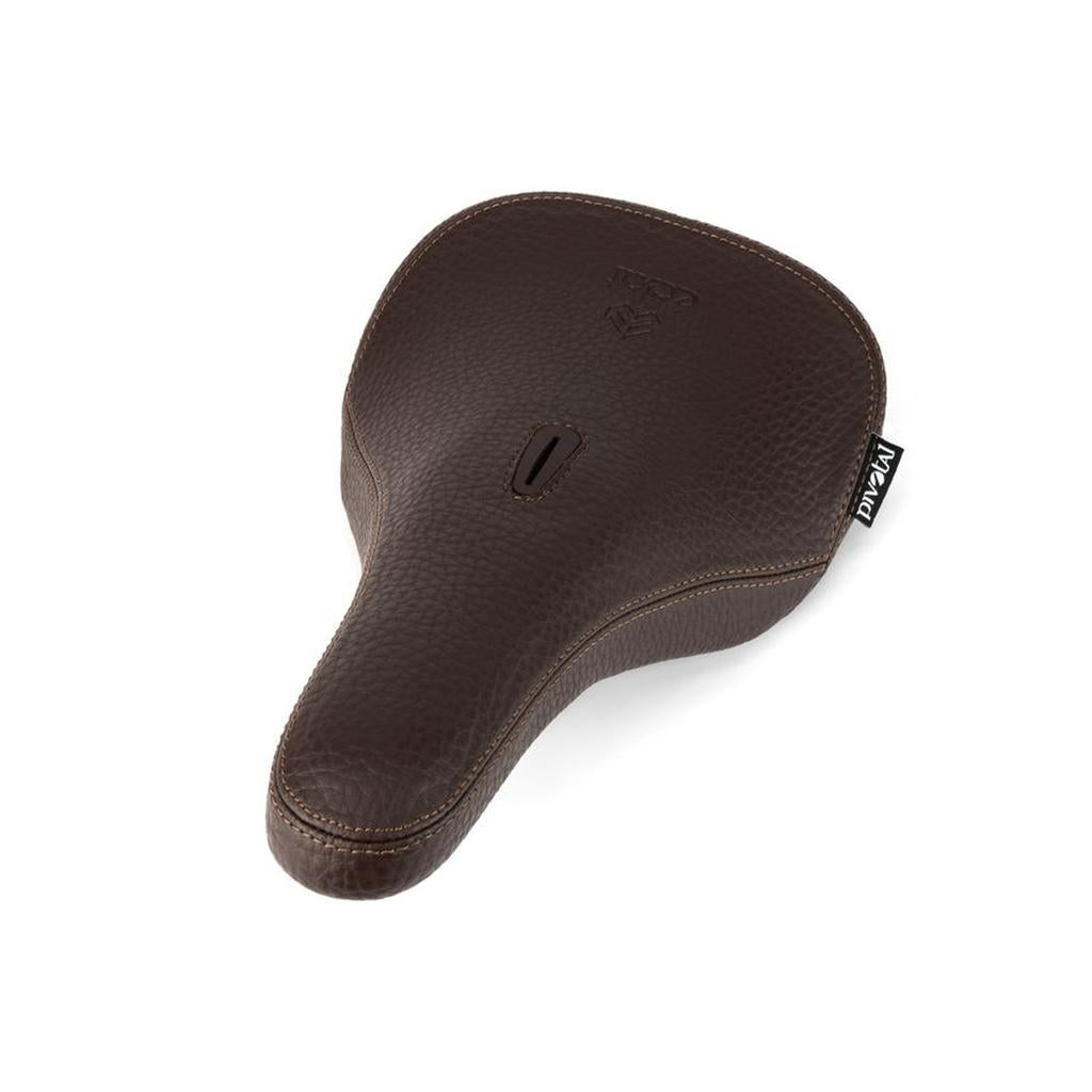 The Eclat Exile Pivotal Seat features a brown textured finish with visible stitching, a central slot for enhanced comfort, and a fabric tag on the side—an ergonomic BMX bike seat designed for both style and performance.