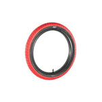 The Family BMX F603 18 Inch Tyre features a red, versatile tread with black sidewalls and is displayed upright against a white background.
