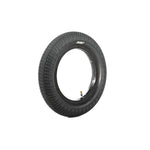 The Family F641 12 Inch Tyre, made of black rubber with a knurled tread and visible air valve, stands upright on a white background.
