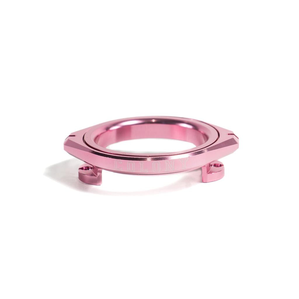 The Colony RX3 Rotary Gyro, a metallic pink CNC alloy bicycle gyro plate with a Nylon bushing bearing, is shown against a white background.