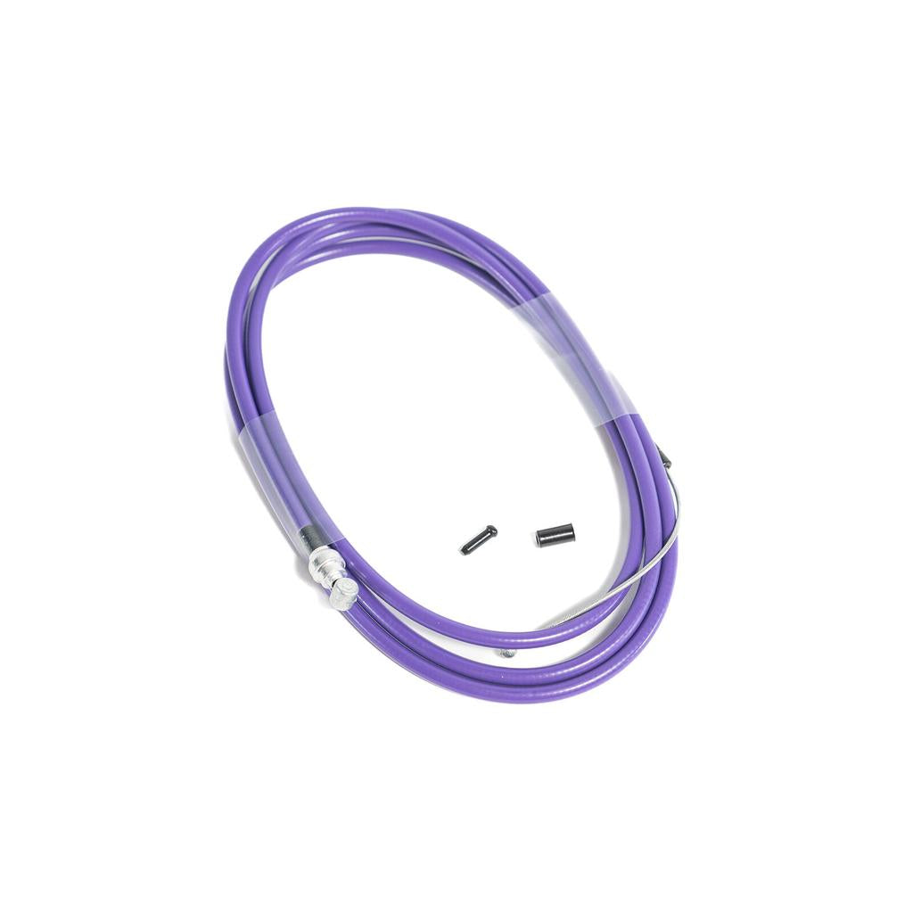 The Family Slick Brake Cable is a coiled purple cable with Teflon lining, metal ends, and includes two small black components, all displayed on a white background.