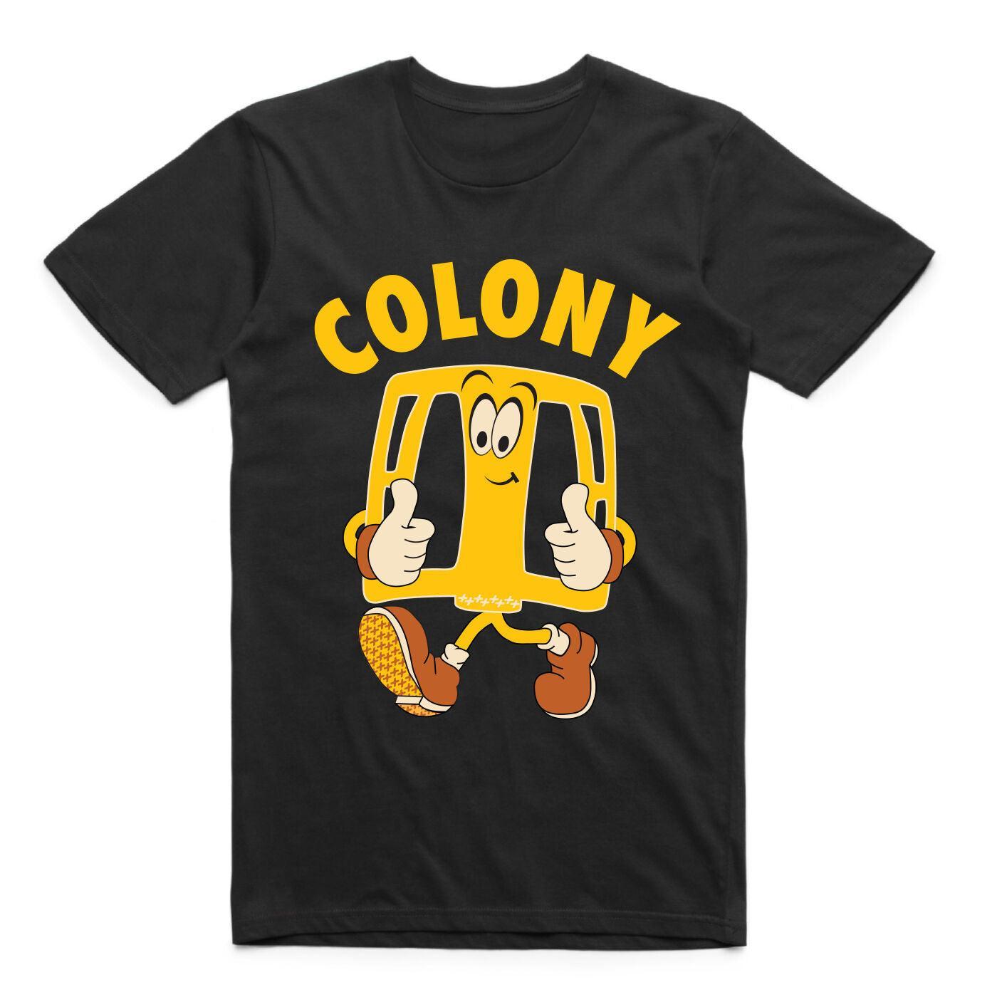 The Colony Pedal Man T-Shirt features "COLONY" and a cartoon yellow bus with a smiling face giving two thumbs up. Made from quality cotton for comfort and style—ideal for any BMX fan or the ultimate Pedal Man.