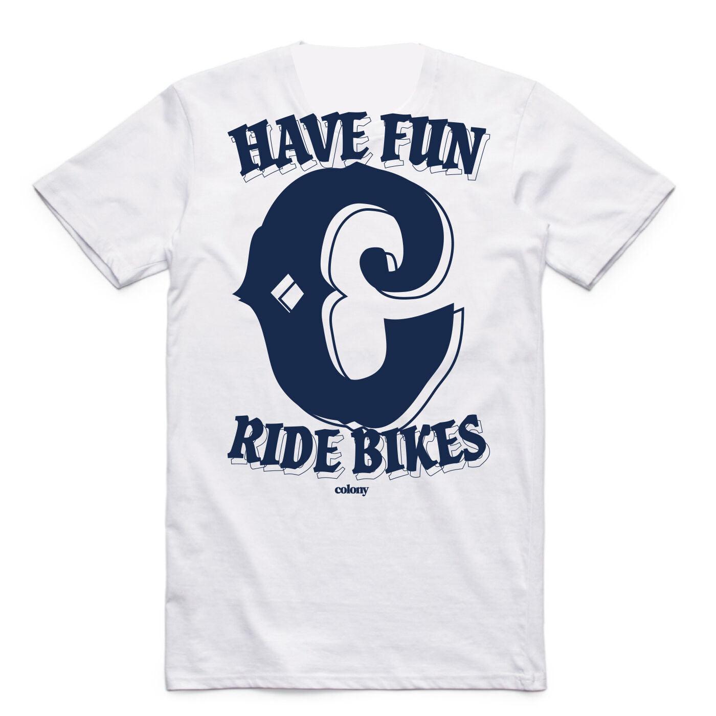 The Colony BMX Have Fun T-Shirt is a regular-fit white tee made from 100% carded cotton, featuring a large navy "C" and the bold slogan "Have Fun Ride Bikes" on the front.