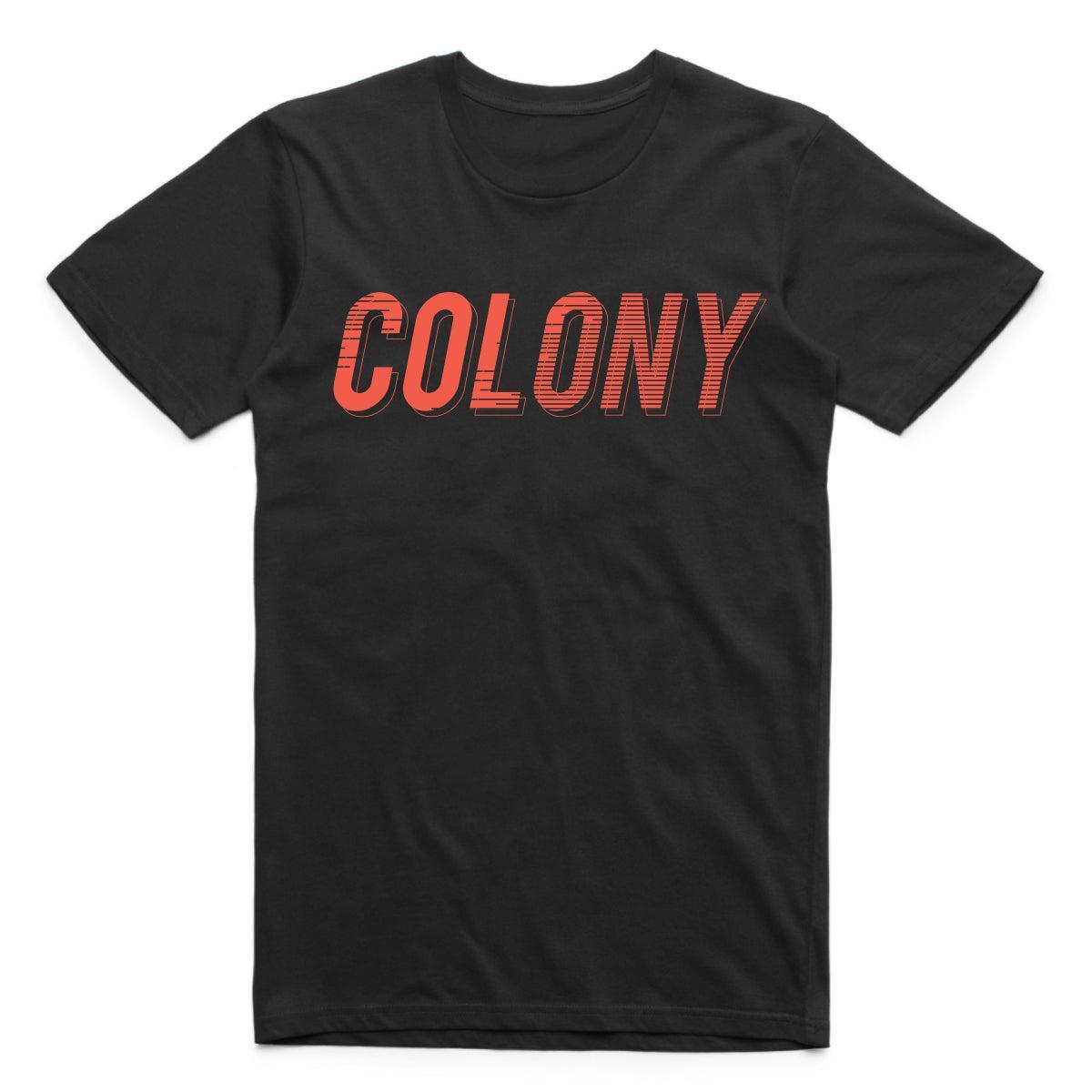 The Colony Momentum T-Shirt is a black tee made from 100% carded cotton, featuring "COLONY" in bold, red, slanted capital letters across the chest.