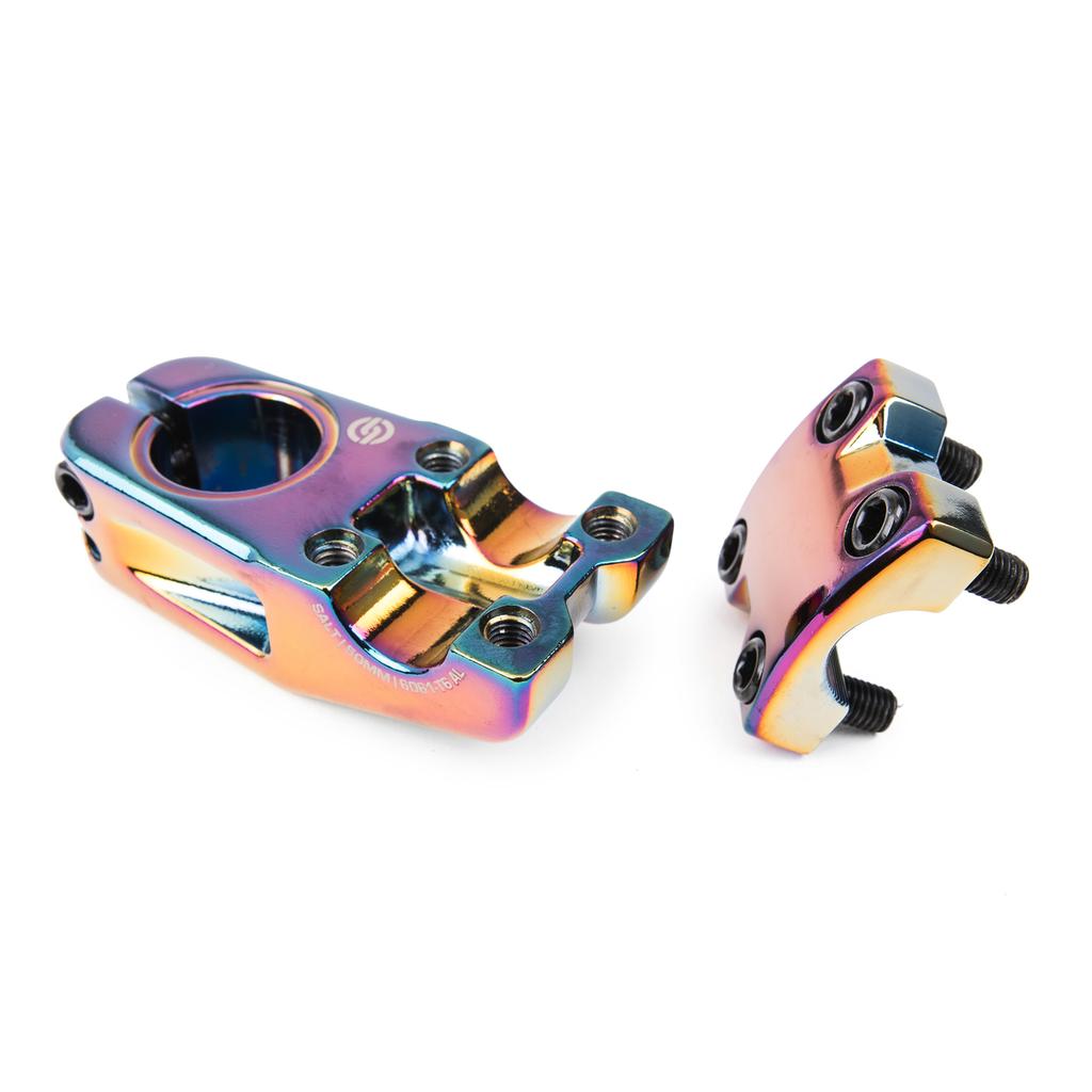 Two iridescent Salt Am V2 Top Load Stem (22.2mm Clamp) BMX stem parts with visible bolts, shown disassembled on a white background. Precision-machined from durable 6061 T6 alloy, these components feature shark tooth clamping for enhanced grip and stability.