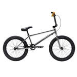The Fit Bike Co Flow 20 Inch Bike features a silver frame, black tires and seat, yellow handlebar grips, and is shown in profile on a white background—ideal for trail or dirt jump riders.