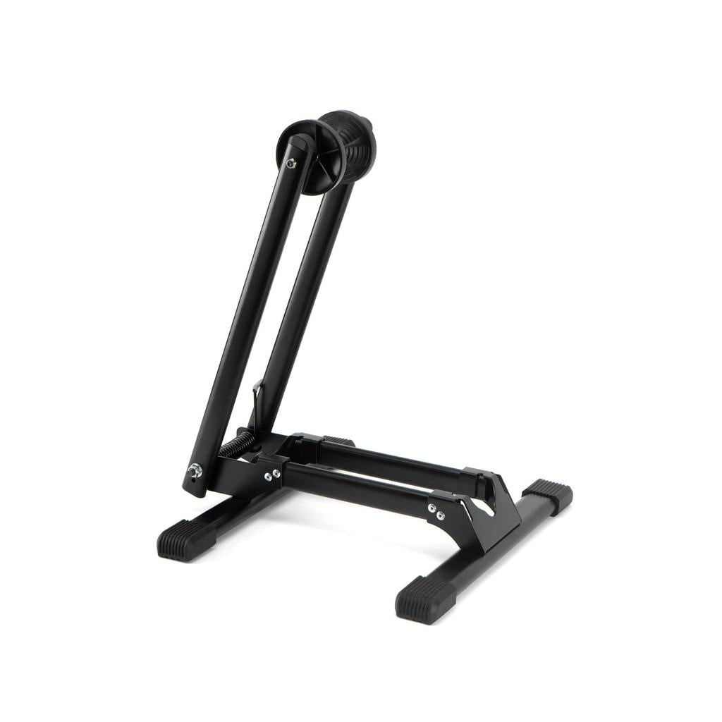 The 6MIL BS-01 Bike Stand is a black, heavy-duty stand with foldable metal arms and rubber-tipped feet, shown upright against a white background.