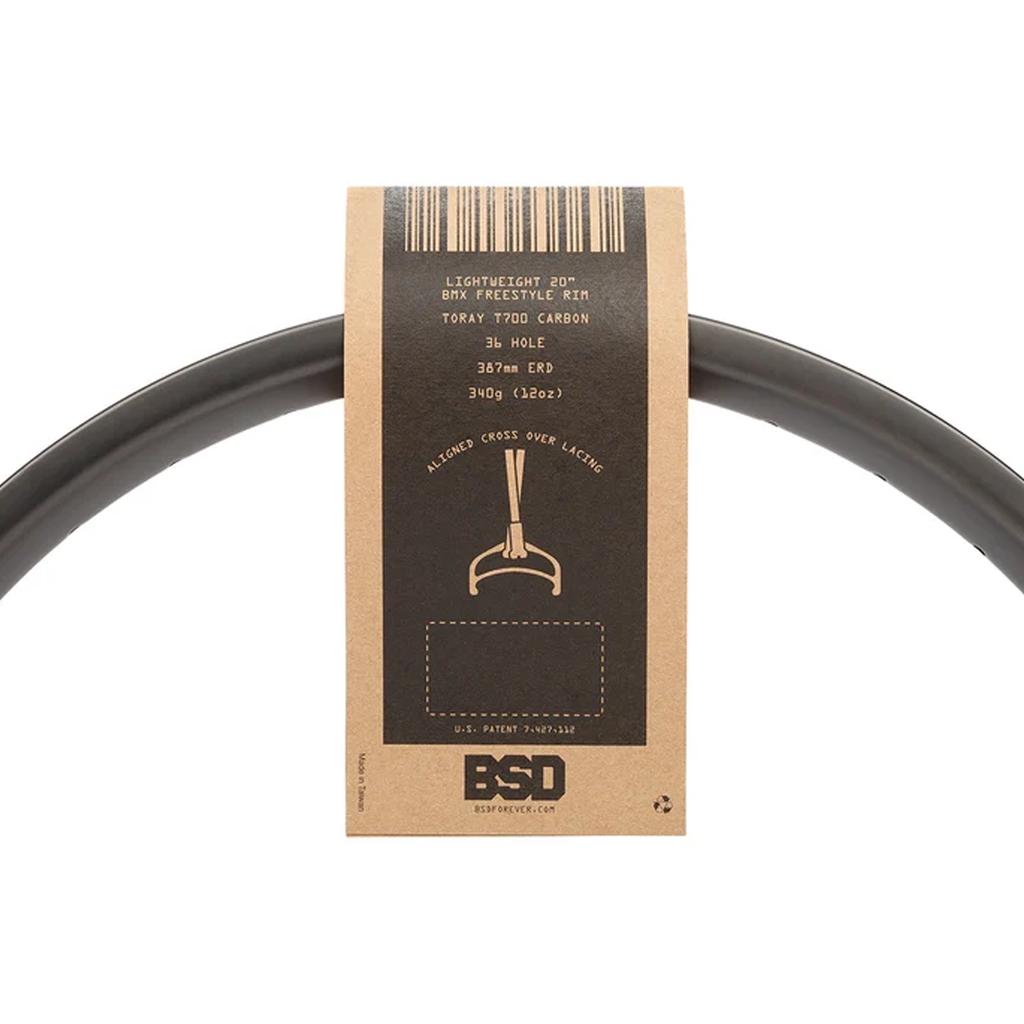 A black 20-inch BSD Crbn-xlt 20 Inch Rim with a brown cardboard product label featuring specifications and a diagram of the rim profile.