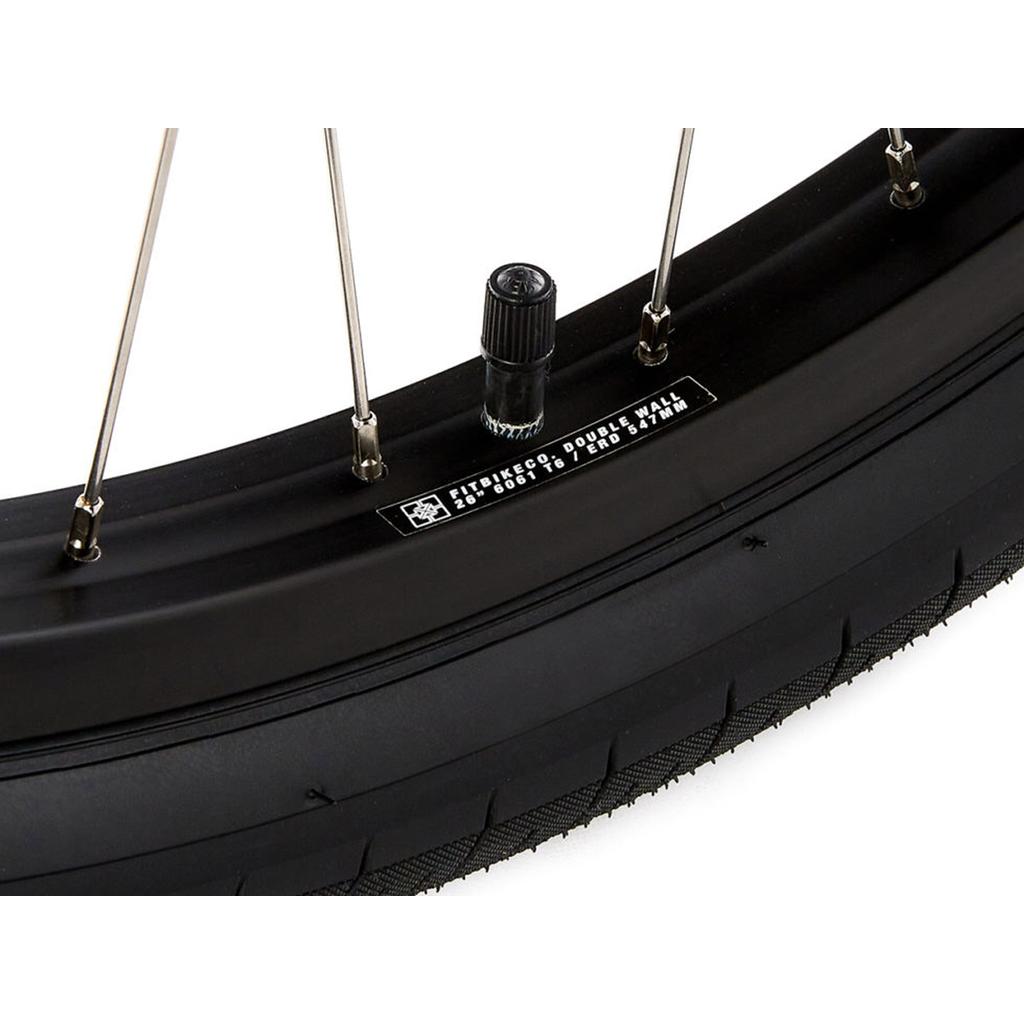 Close-up of the S&M Covid 26 Inch Wheel Set showing the tire, spokes, air valve, and a label on the double wall rims with specifications.