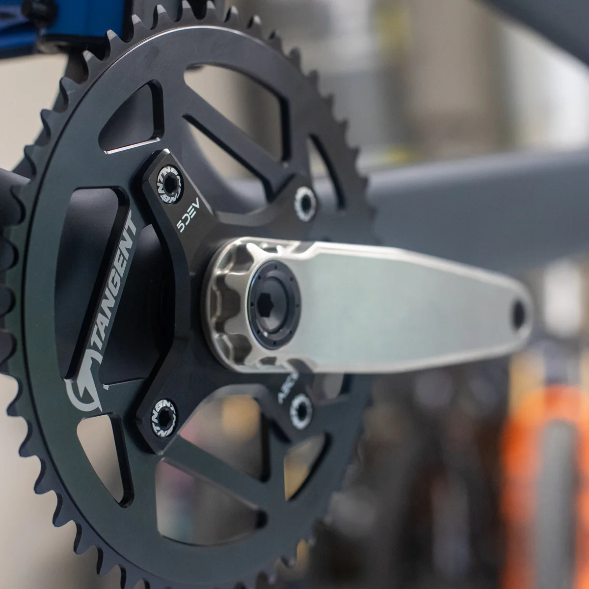 Close-up of lightweight 5DEV Titanium RGXC Cranks and chainring, showing the crank arm attached to the bike frame.