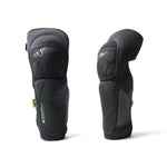 A pair of Fuse NXG Kids Knee Combo Pads, black with visible stitching and "FUSE" branding, stand upright on a white background. Ideal protective gear for kids, these pads offer enhanced safety for knees and shins.