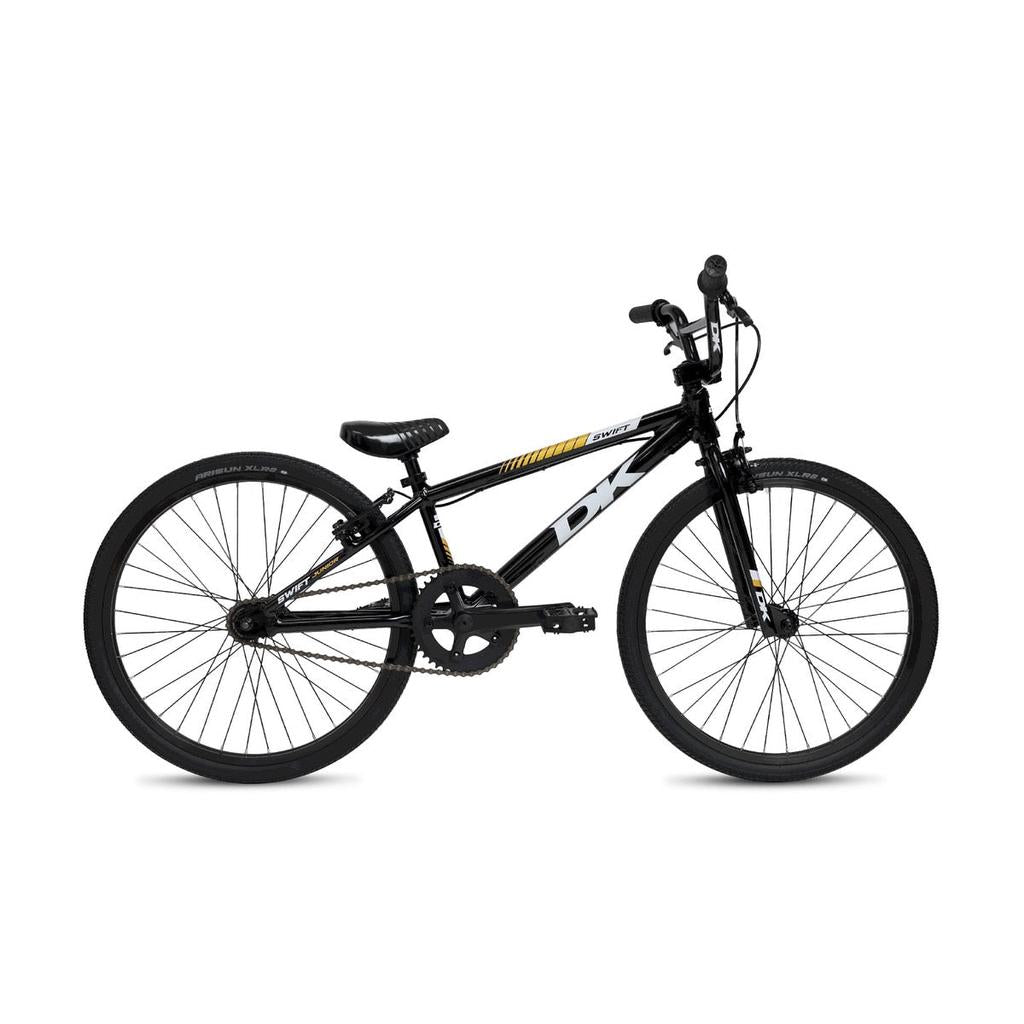The DK Swift Junior 20 Inch Bike 2025, a black BMX bike with a straight top tube, front and rear hand brakes, all-terrain tires, and yellow and white graphics on its lightweight aluminum frame, is shown in profile against a white background.