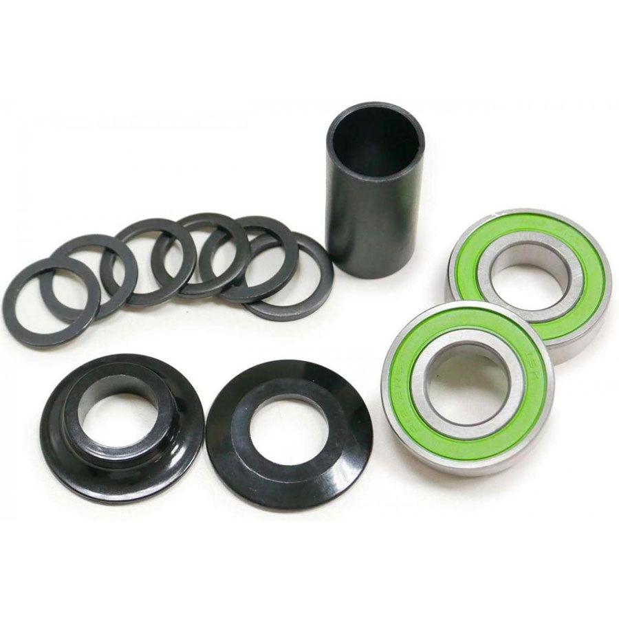 The DRS Mid Bottom Bracket Set features high-quality metal washers, cylindrical components, green-sealed bearings, a black spacer, and durable steel case bearings, all expertly displayed on a white background.