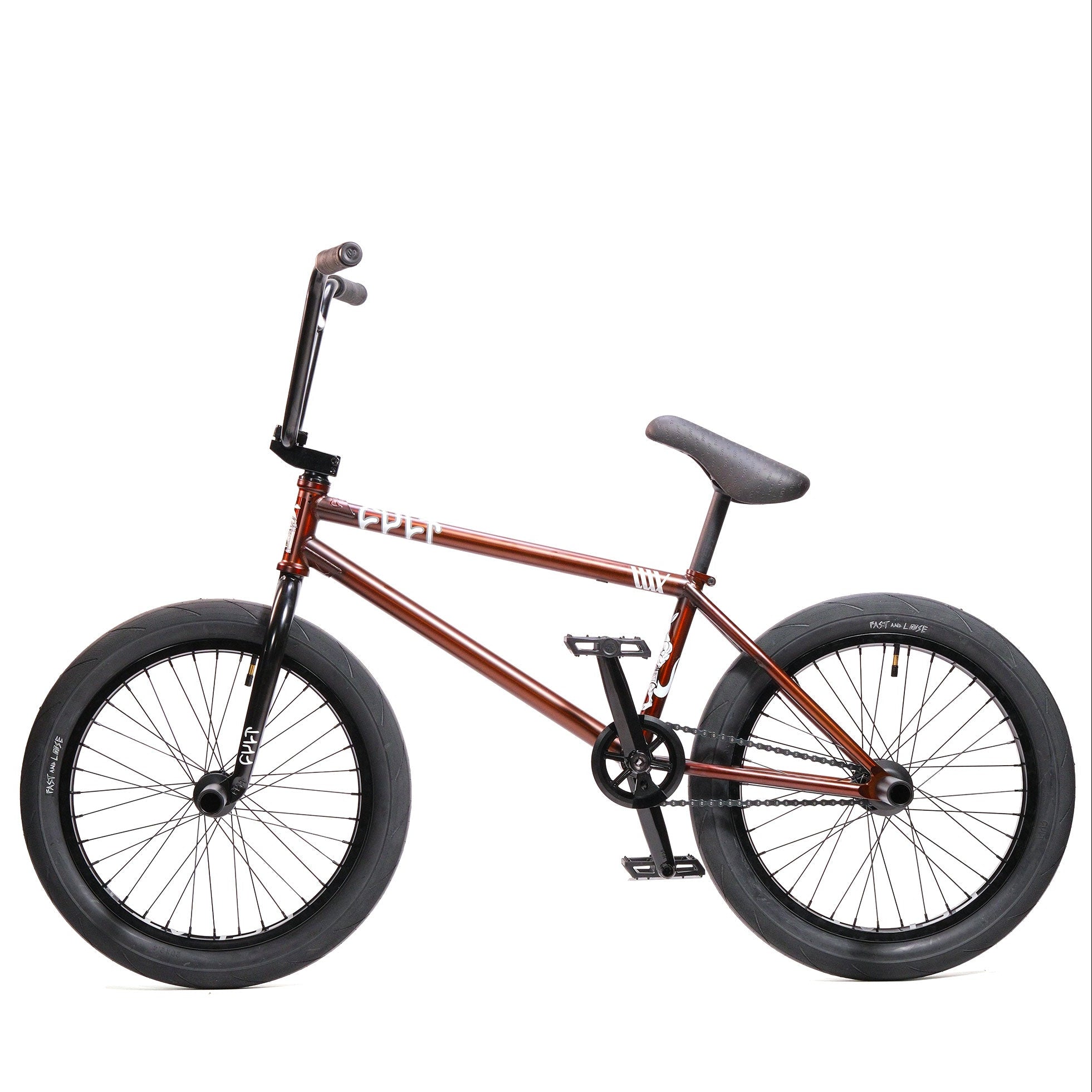 The Cult Dak X Eclat Custom 'Pat Freyne Signature' BMX bike in brown, with black handlebars, seat, pedals, and large black tires, is shown from the side against a white background.