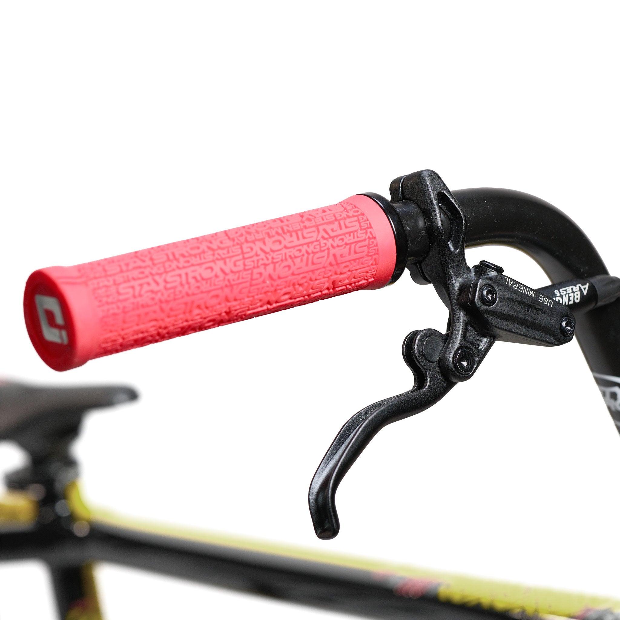 Close-up of the Stay Strong V5.1 Pro XXXL Race Bike’s black handlebar, featuring a red rubber grip and a brake lever; part of the seat and frame is visible in the background, highlighting the precision craftsmanship and robust aluminium frame that define this custom race bike.