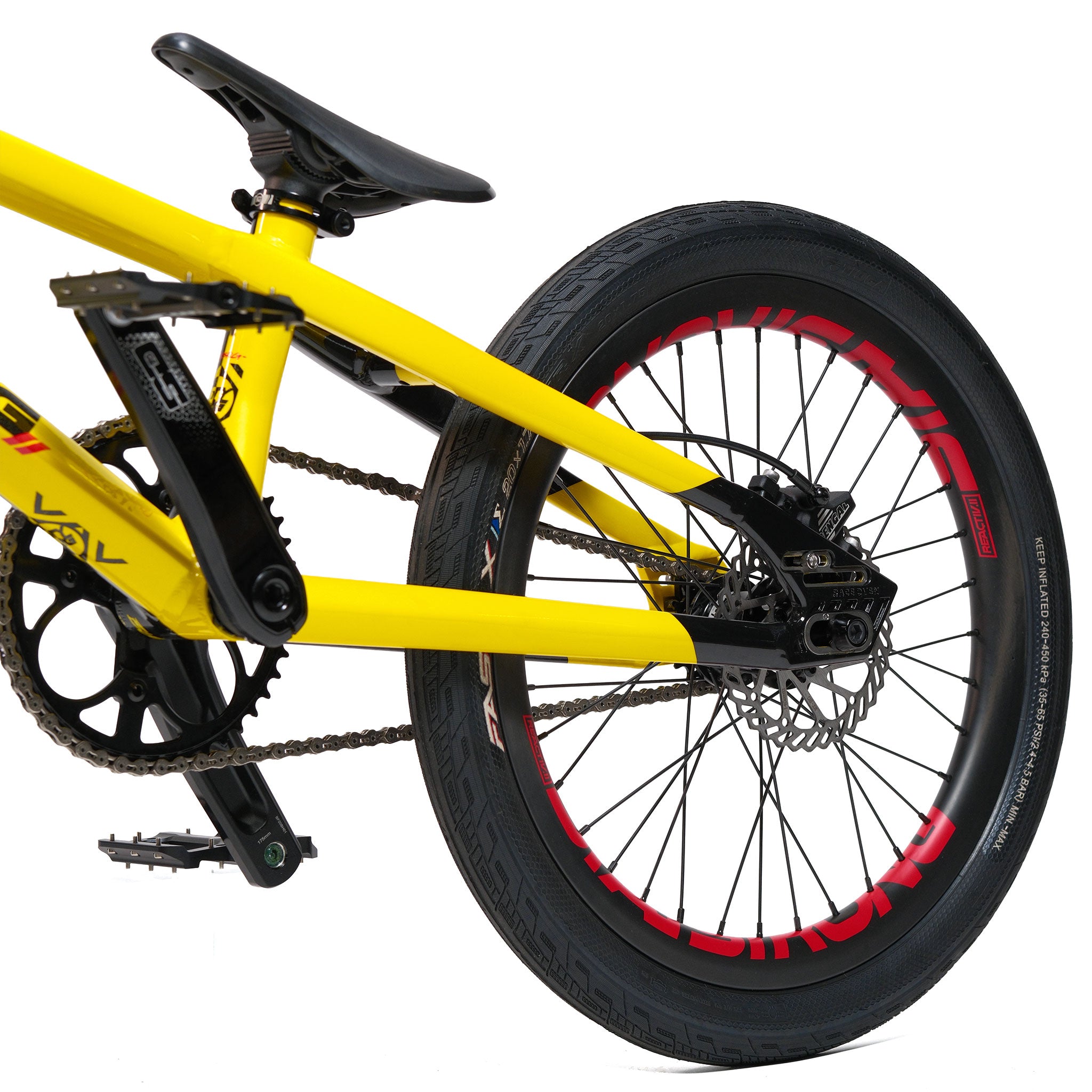 Close-up of the rear section of a yellow Stay Strong V5.1 Pro XXXL Race Bike, built with an aluminium frame, highlighting the pedal, chain, black seat, and rear wheel with a disc brake and red accents on the tire rim—perfect for fans of custom race bikes.